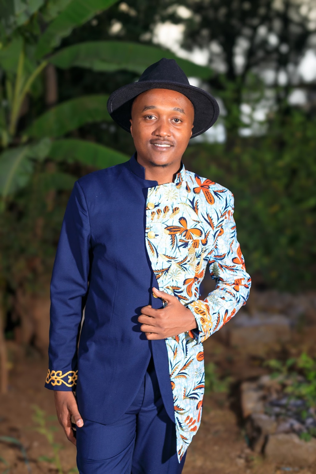 Manasseh in his navy suit and hat